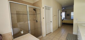 A bathroom with a glass-enclosed shower, a toilet, and a sink. - Modern Bright Contemporary Design 2,400 SF of comfort with Salt Pool & Spa, WiFi (North Port)