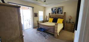 A bedroom with a bed, nightstands, a dresser, and a chair. - Modern Bright Contemporary Design 2,400 SF of comfort with Salt Pool & Spa, WiFi (North Port)