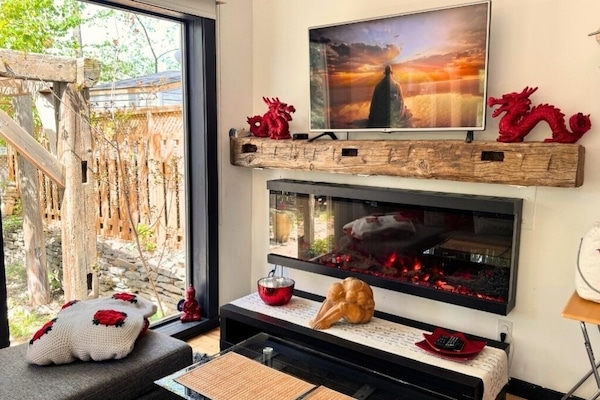 Watching TV by the cozy fireplace inside the Peterborough ZEN Retreat.