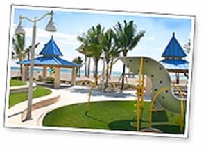 Explore the playground area with gazebos, a climbing structure, and a slide.