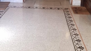 A hallway with a patterned floor, a dark wooden door, and a small window. - Rome-Trastevere. Ideally located. All within walking distance. Internet (Rome)
