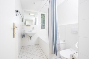 Combined shower/bathtub, hair dryer, soap, toilet paper