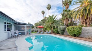 A swimming pool with lounge chairs and palm trees. - Updated! Unbeatable Old Town location with heated pool! (Scottsdale)