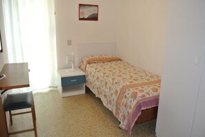 Une chambre à coucher avec un lit, un bureau et une chaise.