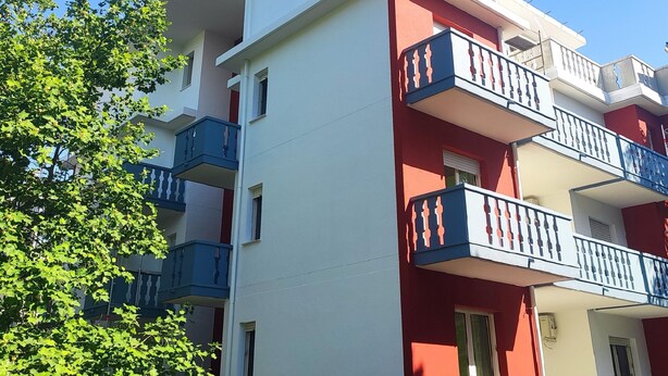 Un immeuble à plusieurs étages doté de balcons et de fenêtres.