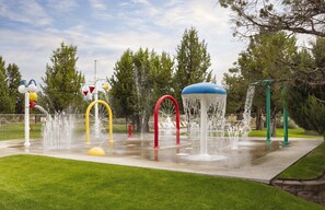 A water play area with multiple fountains and colorful structures. - Awesome summers and gorgeous winters! (Redmond)