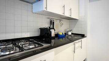 Fridge, coffee/tea maker, cookware/dishes/utensils, spices