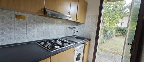 Fridge, microwave, coffee/tea maker, cookware/dishes/utensils