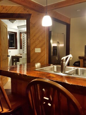 Kitchen bar with the main floor bathroom in the background.