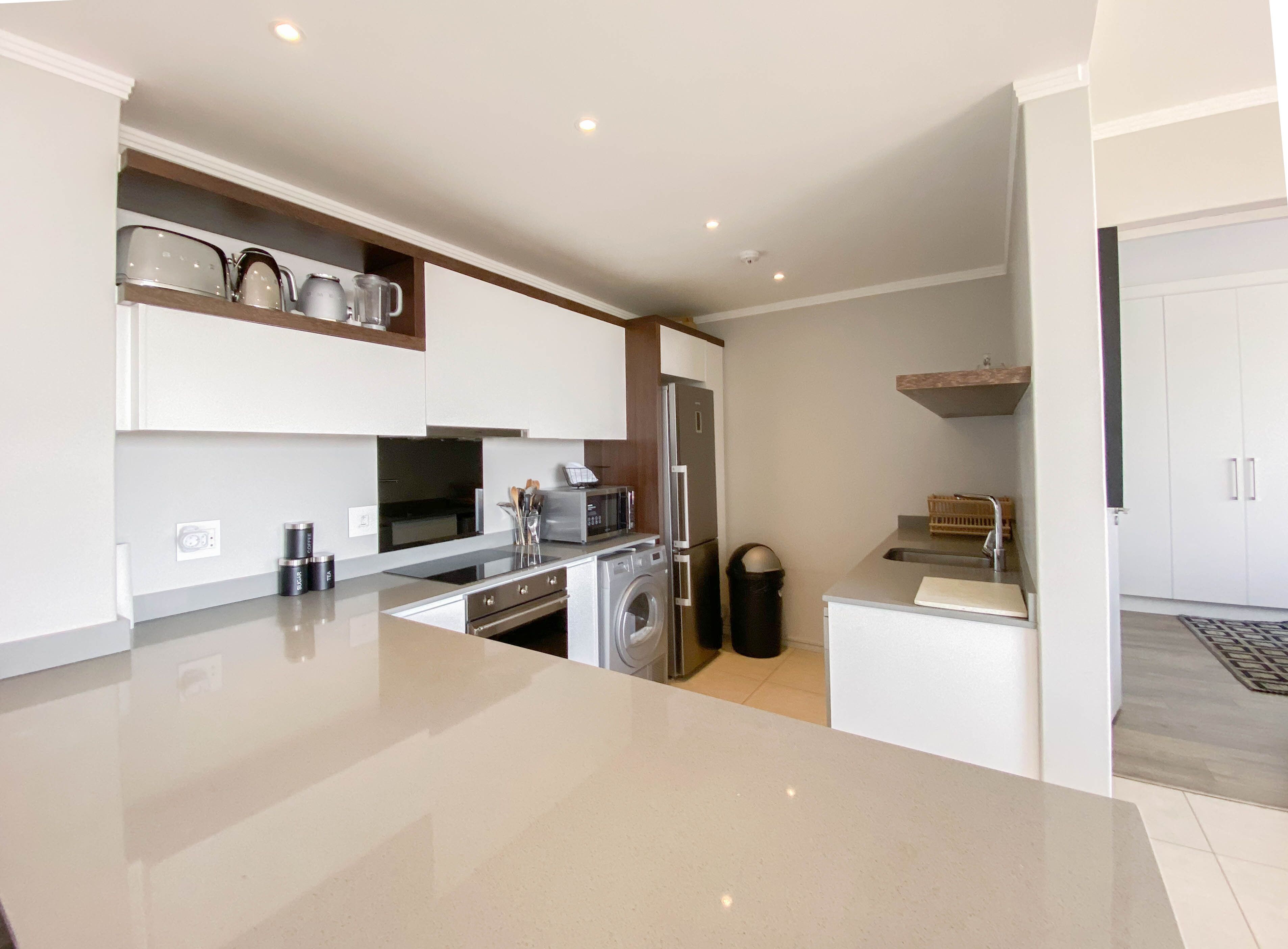 A modern kitchen with a central island, built-in appliances, and ample counter space.