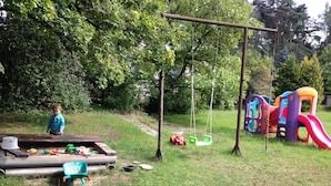 A playground with swings, slides, and a play structure.