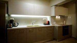A modern kitchen with a sink, toaster, kettle, and coffee maker. - Sandika apartment 8. The right place to be!!! (Koutouloufari)