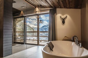 Bathtub, hair dryer, towels, toilet paper
