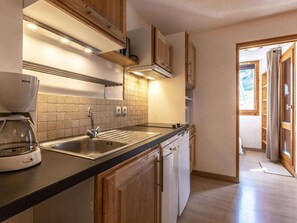A modern kitchen with a Bosch coffee maker, a sink, and a dishwasher.