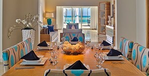 Enjoy meals in this dining area with a long table and comfortable seating for all.