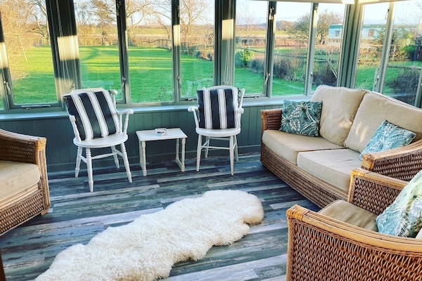 Conservatory with plenty of seating.