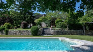 A swimming pool with stone steps leading up to a stone building surrounded by lush greenery. - Villa San Michele, Gaiole in Chianti, Siena and Chianti (Gaiole in Chianti)
