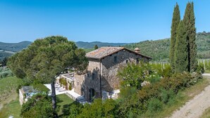 A stone building with a tiled roof, surrounded by trees and a clear sky. - Il Casetto, Radda in Chianti, Siena and Chianti (Radda in Chianti)