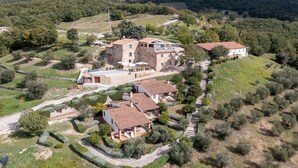 An aerial view of a countryside property with multiple buildings, stone walls, and a well-maintained garden. - Anna, Fattoria la Pieve, Roccalbegna, Grosseto and Maremma (Roccalbegna)