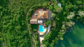An aerial view of a house with a swimming pool, surrounded by dense greenery and a lake. - Casale del Lago, San Casciano in Val di Pesa, Florence and Chianti (San Casciano in Val di Pesa)