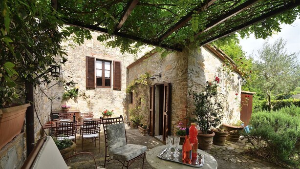 A rustic stone building with a covered patio, outdoor seating, and potted plants. - Mastro 3, San Sano, Gaiole in Chianti, Siena and Chianti (Gaiole in Chianti)