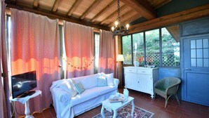 A cozy room with a sofa, a television, a dining table, and a chair. - Il Paretaio, Montevarchi, Arezzo and Cortona (Montevarchi)
