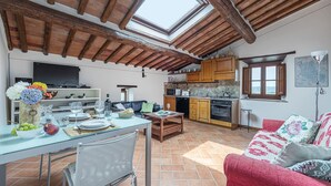 A cozy living room with a dining area, kitchen, and a skylight. - Bella Vista, Montebuoni, Gaiole in Chianti, Siena and Chianti (Gaiole in Chianti)