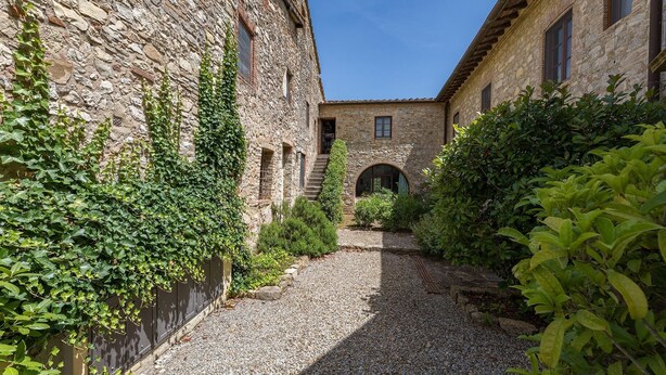A courtyard with stone buildings, a gravel path, and greenery. - Santa Lucia, Montebuoni, Gaiole in Chianti, Siena and Chianti (Gaiole in Chianti)