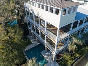 A multi-story building with balconies and a swimming pool.