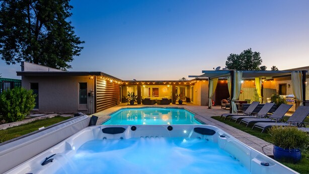 A modern outdoor pool area with a hot tub, lounge chairs, and a covered seating area. - Most desirable neighborhood in Scottsdale.  2 masters, private 1 acre lot (Scottsdale)