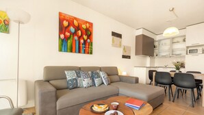 A modern living room with a sofa, coffee table, and artwork on the wall. - Porto Letizia S5, Porlezza, Italy (Porlezza)