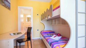 A compact room with a bunk bed, a desk with a chair, and a small bathroom visible through an open door. - Porto Letizia Deluxe, Porlezza, Italy (Porlezza)