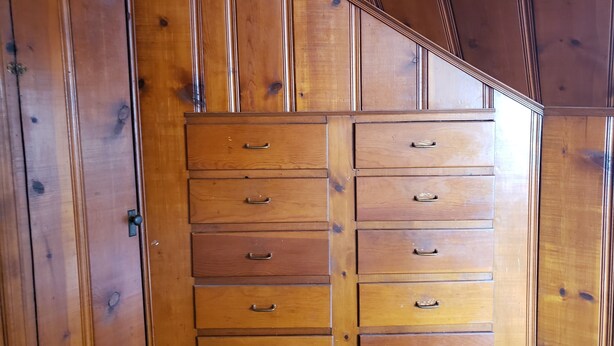 Een houten dressoir met meerdere lades en handgrepen.
