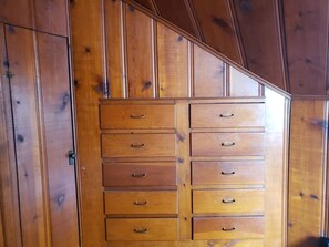 A wooden dresser with multiple drawers and handles.