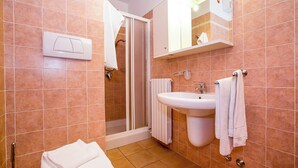 A bathroom with a shower, sink, and towel rack. - Porto Letizia Dalia 4, Porlezza, Italy (Porlezza)