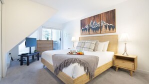 A bedroom with a bed, bedside tables, a desk, a painting, and a window. - Luxury 3Br TH- Private Hot Tub/AC/Pool/Bike Storage (Whistler)