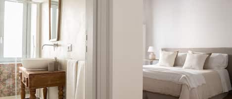 A bathroom with a large sink, mirror, and wooden vanity.
