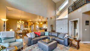 A spacious living room with a sectional sofa, a coffee table, and a dining area in the background. - Sky Valley Home w/ Mtn View, 5 Mi to Rabun Bald! (Sky Valley)