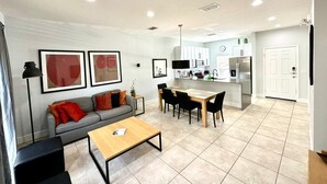 A modern apartment with a living room, dining area, and kitchen. - A Dream Villa next to Disney. (Kissimmee)