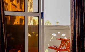 Sliding glass door leads to an outdoor area with a view.