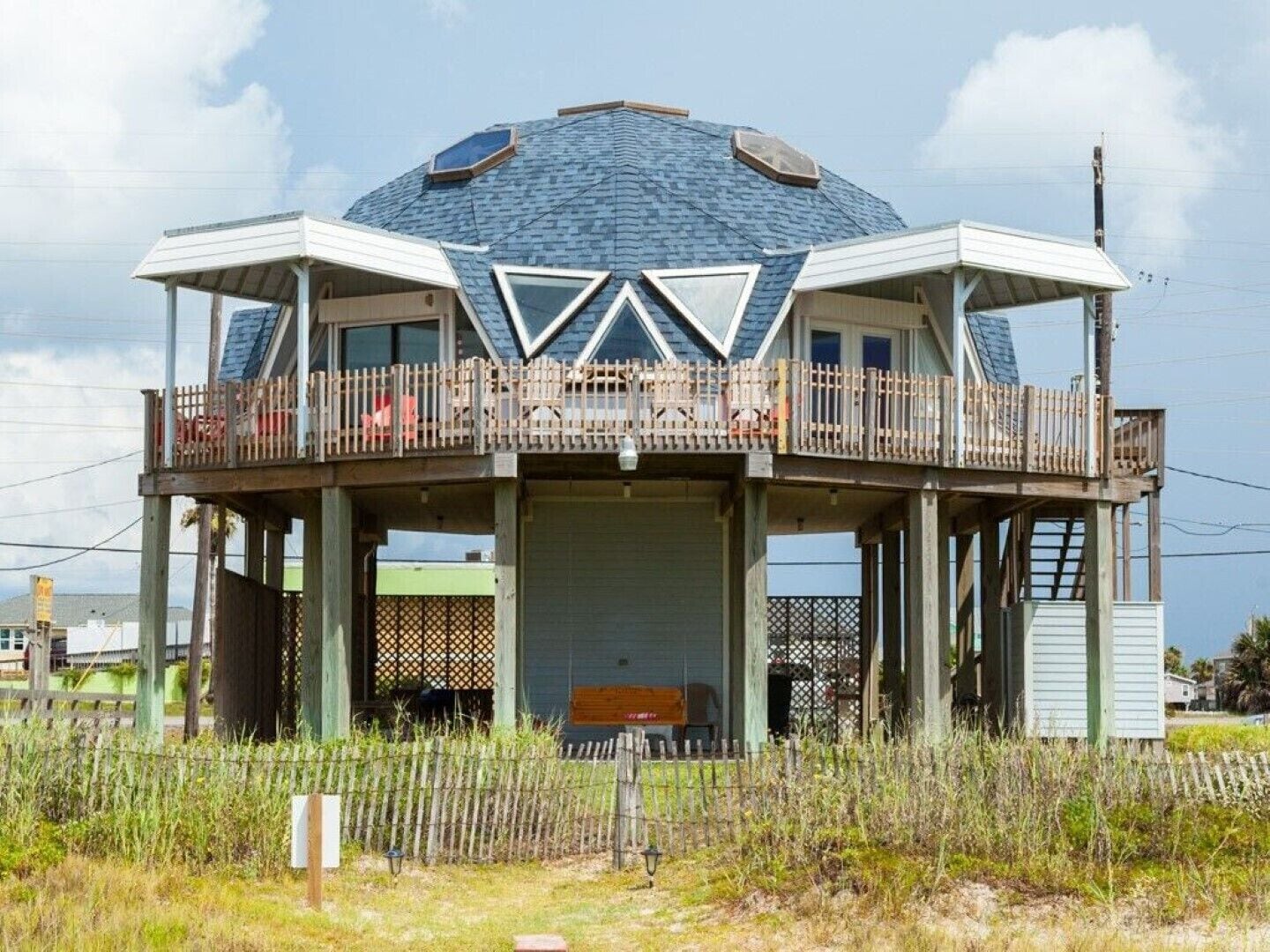A dome-shaped building with a balcony and a covered area.