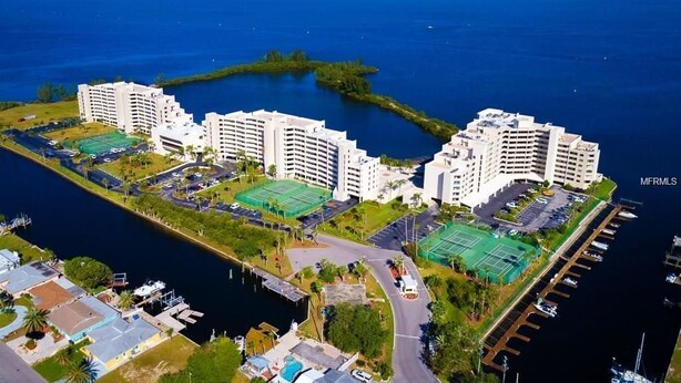A high-rise hotel with multiple balconies overlooking a marina and the ocean. - Paradise Island (Hudson)