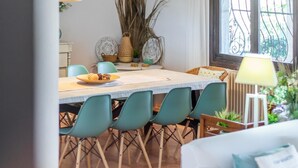A dining area with a table, chairs, and a window with a view. - Luxurious Villa Tosalet area with panoramic sea views (Jávea)