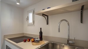 A modern kitchen with a stainless steel sink, a built-in oven, and a window above the sink. - Puglia holiday apartment in Monopoli (Monopoli)