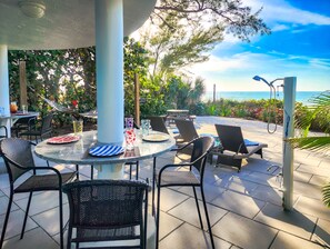 Outdoor dining - Luxurious Oceanfront Home w/ MILES of sandy beach & private Inter-Coastal dock! (Indian Shores)
