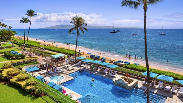A resort with a large swimming pool, beach access, and palm trees. - AMAZING VIEW!  1 Back from Oceanfront 1bed/2 bath (Lahaina)