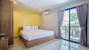 A bedroom with a bed, a wooden wardrobe, a potted plant, and a balcony with curtains. - Goodtimes Pool Villa 2 (Walk TO Beach) (Hua Hin)