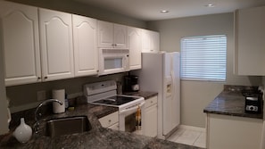 Microwave, dishwasher, coffee/tea maker, cookware/dishes/utensils