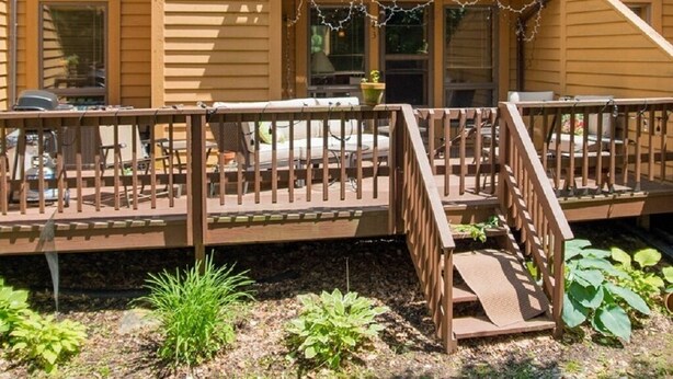 A two-story house with a balcony, a deck, and a chimney. - Cozy, Beautifully Furnished Condo 10  Minutes to Ski Resorts (Davis)