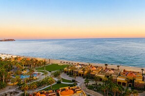 A resort with a pool, palm trees, and a view of the sea. - Bella Sirena Oceanfront 3BR Penthouse – Steps from the Beach + Stunning Views! (Puerto Peñasco)